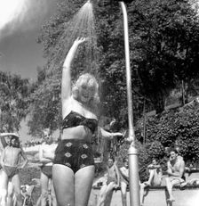 A refreshing shower during the heatwave in Stockholm, Sweden, 24th July 1943. Creator: Karl Sandels