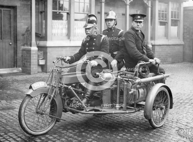 A Rex motorcycle being used by firemen. Artist: Unknown