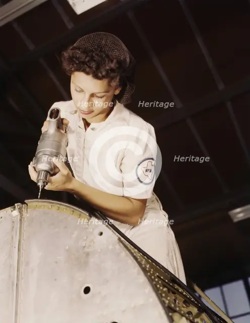 A rivet is her fighting weapon..., Naval Air Base, Corpus Christi, Texas, 1942. Creator: Howard Hollem.