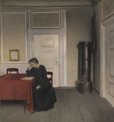 A Room in the Artist's Home in Strandgade, Copenhagen, with the Artist's Wife, 1902. Creator: Vilhelm Hammershøi