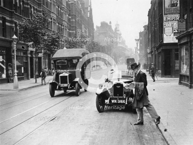 A Rover 1928 10/25 HP sports car parked in a London street, 1931. Artist: Unknown