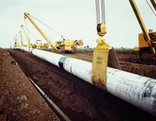 A row of Caterpillar 583 pipelayers with side booms, lifting the Fens gas pipeline, Norfolk, 08/1967 Creator: John Laing plc