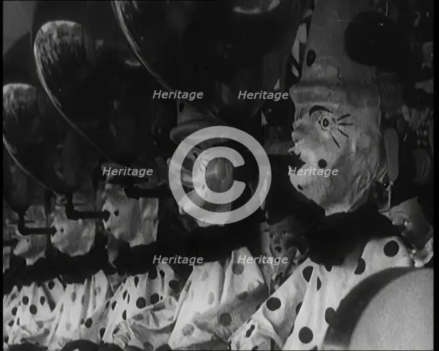 A Row of Clown Figures With Balloons Forming Part of a Game, 1924. Creator: British Pathe Ltd.
