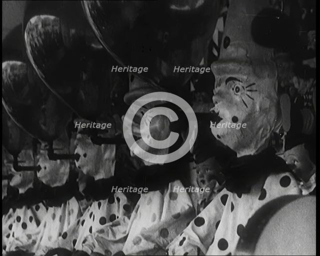 A Row of Clown Figures With Balloons Forming Part of a Game, 1924. Creator: British Pathe Ltd.