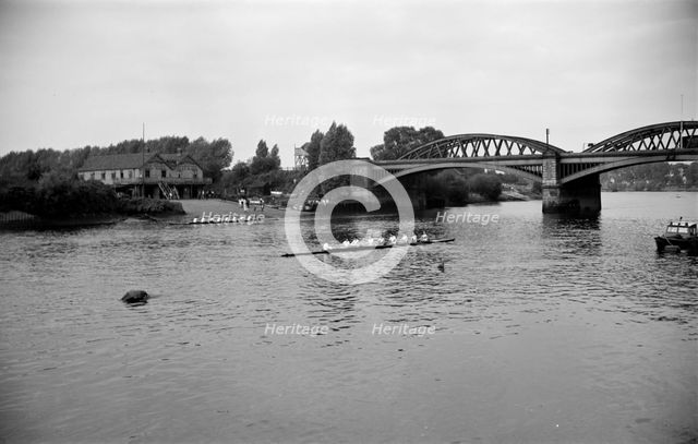 A rowing eight approaches Barnes Bridge, Chiswick, London, c1945-c1965. Artist: SW Rawlings