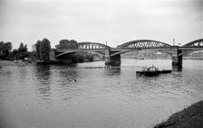 A rowing eight passes under Barnes Bridge, Chiswick, London, c1945-c1965. Artist: SW Rawlings