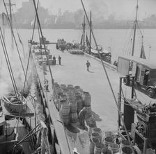 A scene at the Fulton fish market showing the dock where New England fishing, New York, 1943. Creator: Gordon Parks