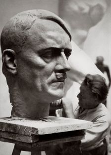 A sculptor working on a large portrait bust of Adolf Hitler, Germany, 1936