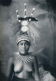 A Samoan woman wearing a collar of cachalots teeth and a ceremonial headdress, 1902. Artist: Josiah Martin