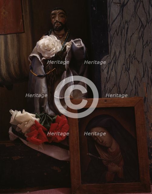 A Santo bulto and a painting of the Dolorosa in the church, Trampas, New Mexico, 1943. Creator: John Collier.