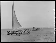 A sand yacht on West Wittering Beach with people digging in the sand, Chichester, West Sussex, 1930s Creator: George R Long