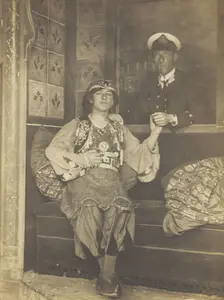 A sailor holds hands with a man in elaborate drag, [between 1910 and 1999?]. Creator: Unknown