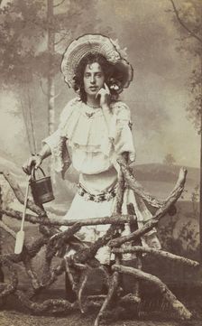 A sailor in drag posed behind a wooden fence, 1906. Creator: Unknown