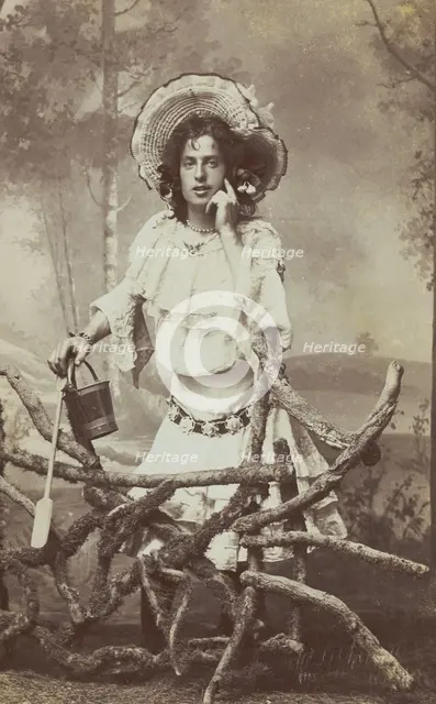A sailor in drag posed behind a wooden fence, 1906. Creator: Unknown.