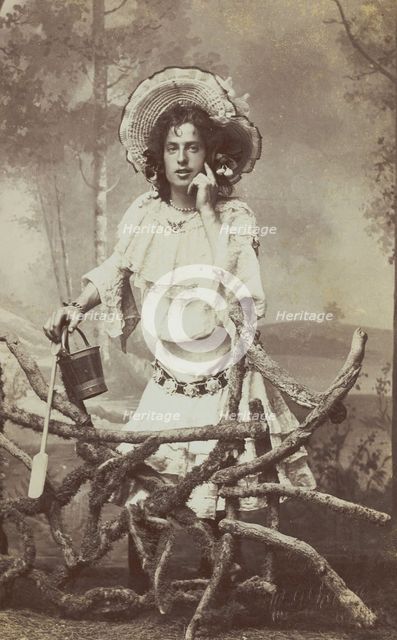 A sailor in drag posed behind a wooden fence, 1906. Creator: Unknown.