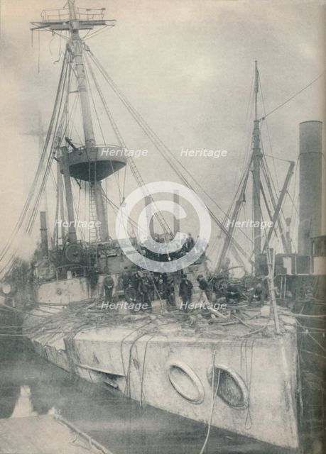'A Salvage Triumph. The cruiser Gladiator, supported by salvage tugs', 1908, (1936). Artist: Unknown.
