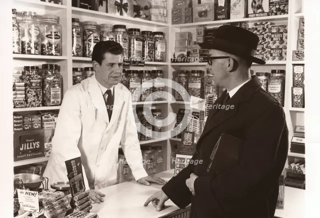 A salesman talking to a shopkeeper, 1956. Artist: Unknown