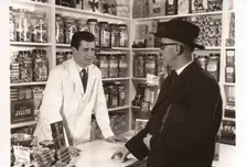A salesman talking to a shopkeeper, 1956
