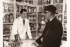 A salesman talking to a shopkeeper, 1956