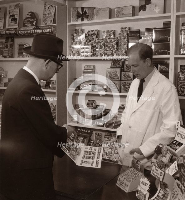 A salesman demonstrating his goods, 1956. Artist: Unknown