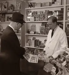 A salesman demonstrating his goods, 1956