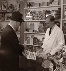 A salesman demonstrating his goods, 1956