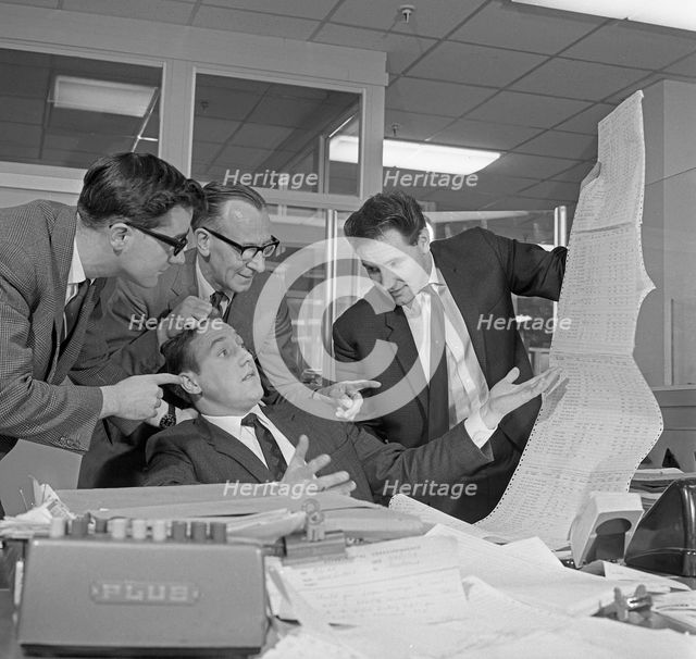 A salesman gets a helping hand in checking the figures, 1967.  Creator: Michael Walters.