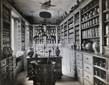 A seventeenth-century German apothecary's shop with ornate pharmacy jars..., c1900s. Creator: Christof Muller
