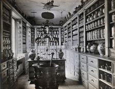 A seventeenth-century German apothecary's shop with ornate pharmacy jars..., c1900s. Creator: Christof Muller
