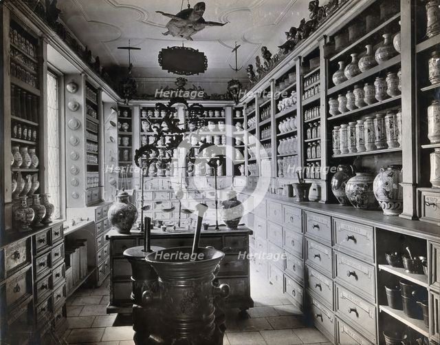 A seventeenth-century German apothecary's shop with ornate pharmacy jars..., c1900s. Creator: Christof Muller.