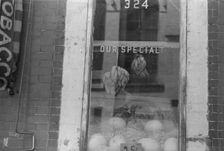 A shop window, 61st Street between 1st and 3rd Avenues, New York, 1938. Creator: Walker Evans