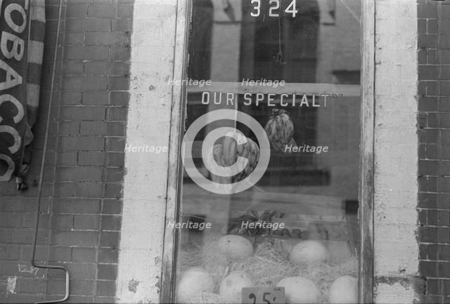 A shop window, 61st Street between 1st and 3rd Avenues, New York, 1938. Creator: Walker Evans.