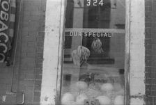 A shop window, 61st Street between 1st and 3rd Avenues, New York, 1938. Creator: Walker Evans
