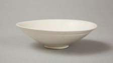 A shallow cream glazed bowl with rolled rim andraised footrim, Tang dynasty, c.800-900. Creator: Unknown