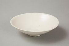 A shallow cream glazed bowl with rolled rim andraised footrim, Tang dynasty, c.800-900. Creator: Unknown