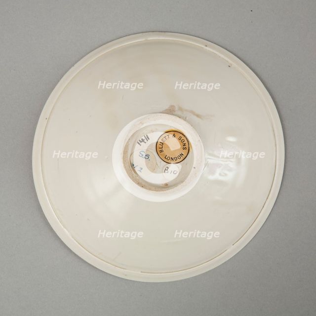 A shallow cream glazed bowl with rolled rim andraised footrim, Tang dynasty, c.800-900. Creator: Unknown.