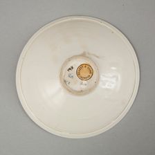 A shallow cream glazed bowl with rolled rim andraised footrim, Tang dynasty, c.800-900. Creator: Unknown