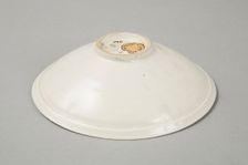 A shallow cream glazed bowl with rolled rim andraised footrim, Tang dynasty, c.800-900. Creator: Unknown