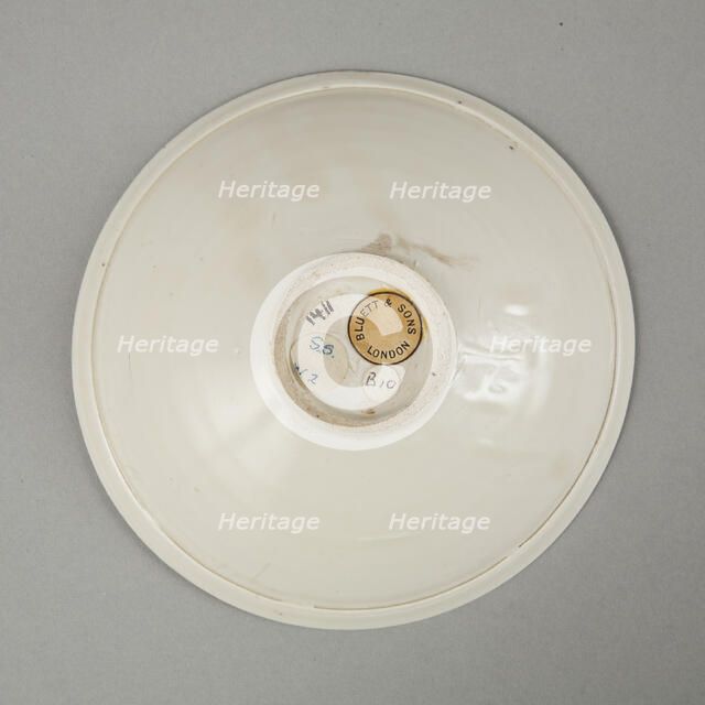 A shallow cream glazed bowl with rolled rim andraised footrim, Tang dynasty, c.800-900. Artist: Unknown.