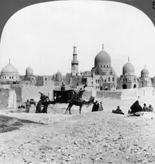 A Ship of the Desert passing tombs of by-gone Moslem rulers, Cairo, Egypt 1905.Artist: Underwood & Underwood