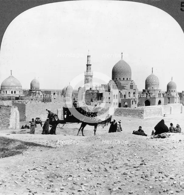 'A 'Ship of the Desert' passing tombs of by-gone Moslem rulers, Cairo, Egypt', 1905.Artist: Underwood & Underwood