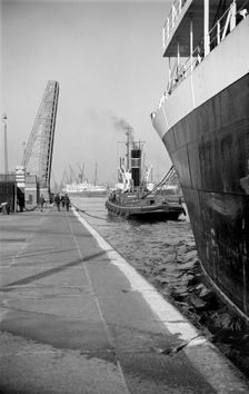 A ship being towed into the King George V Dock, Canning Town, London, c1945-c1965. Artist: SW Rawlings