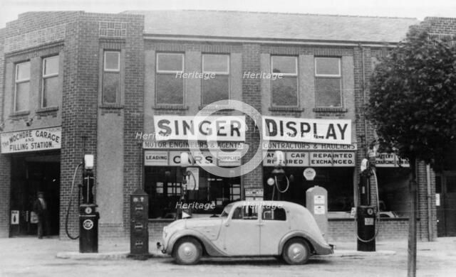 A Singer 11hp Airstream saloon car outside a Welsh garage, Wales, 1935. Artist: Unknown