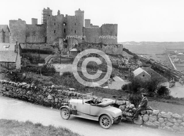 A Singer car in front of Harlech Castle, Wales, early 1920s. Artist: Unknown