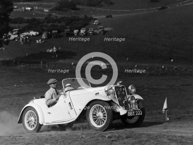A Singer Nine Le Mans climbing a hill, 1935. Artist: Unknown