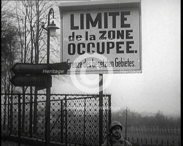 A Sign Read 'Limite de la Zone Occupee. Grenze des Besetzten Gebietes', a French Soldier..., 1924. Creator: British Pathe Ltd.