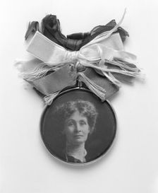 A silver and glass badge with a medallion portrait of Emmeline Pankhurst, c1908