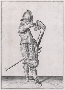 A soldier charging his caliver which is held stock down, from the Marksmen serie..., published 1608. Creator: Robert Willemsz de Baudous