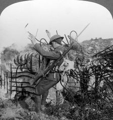 A soldier triggers a booby trap, World War I, 1914-1918.Artist: Realistic Travels Publishers