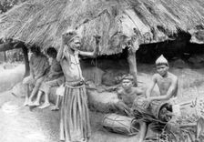 A sorcerer ejecting a spirit from a sick man in South India, 1926